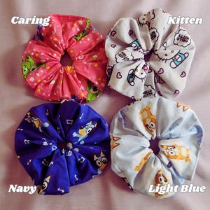 Handmade Cotton Scrunchies Nostalgic Design Collection Retro Aesthetic Hair Ties Video Game Inspired Accessories Nineties Style Fashion Statement Millennial Gift Idea Vintage Look Cartoon Character Elements Colorful Pattern Comfortable
