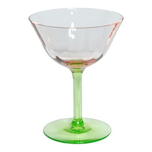May include: A clear cocktail glass with a pink rim and a green stem and base. The glass has a textured bowl and a classic coupe shape, ideal for serving cocktails. The stem and base are a vibrant green.
