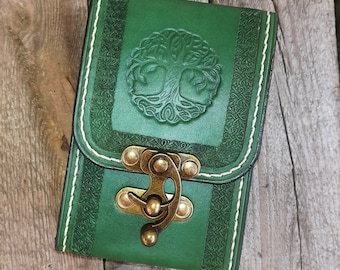 May include: A green leather wallet with a tree of life design and a brass clasp.