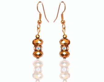 Gold crystal beaded earrings in glass bottle