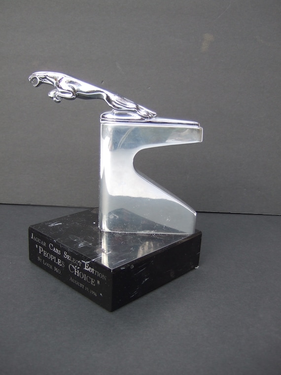 Sleek Jaguar Chrome Plated Hood Ornament on Black Marble Pedestal