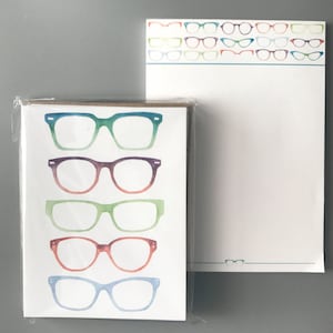 May include: A set of blank note cards with a watercolor design of colorful eyeglasses. The cards are packaged in a clear plastic sleeve.