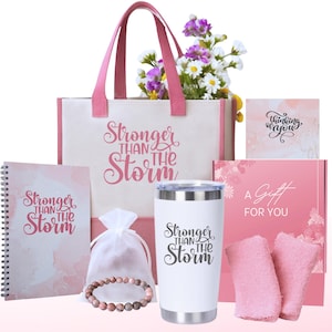 May include: A gift set with a pink tote bag, a journal, a tumbler, a bracelet, a small bag, and two pink washcloths. The tote bag, journal, and tumbler all have the text "Stronger Than The Storm" printed on them. The gift set is perfect for someone who needs a little encouragement.