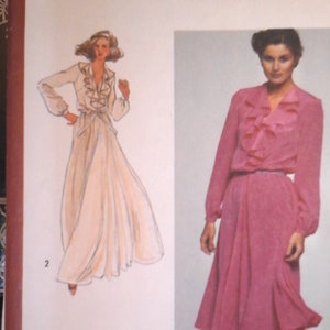 May include: Simplicity sewing pattern number 9655 for a dress. The pattern is for size 12 miss. The pattern shows two models wearing the dress. One model is wearing a white dress and the other is wearing a pink dress.