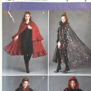May include: Simplicity sewing pattern number 1294 OS for a cape. The pattern includes four different styles of capes: a red cape with ruffles, a black cape with sequins, a black cape with a ruffled collar, and a red hooded cape. The pattern is designed and printed in the USA.