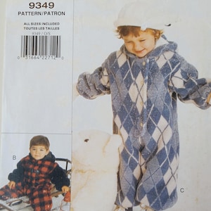 May include: Vogue for Me pattern 9349. The image shows a child wearing a blue and white diamond-patterned snowsuit with a hood and matching hat. Other images show children in red and black plaid snowsuits. The pattern includes all sizes.