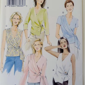 May include: Vogue basic design sewing pattern V7876 for wrap tops. The pattern includes multiple wrap top designs with varying sleeve lengths and details. The image shows illustrations of the finished garments, with the pattern number and size information visible.