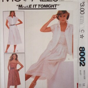 May include: A vintage McCall's sewing pattern for a dress, featuring three different styles. The pattern is labeled "Make It Tonight" and is for a size 12, bust 34. The pattern is printed on white paper with blue and black text.
