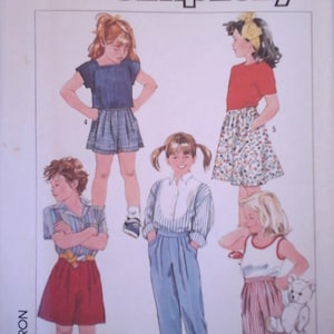 May include: Simplicity sewing pattern number 7409 for girls' clothing. The pattern includes instructions for making a variety of tops, shorts, and skirts. The pattern is for sizes 6X.