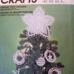 May include: Crochet Christmas tree topper and ornaments pattern. The pattern includes instructions for making a star-shaped tree topper, wreaths, and a ball ornament. The pattern is from McCall's Crafts and is numbered P903.