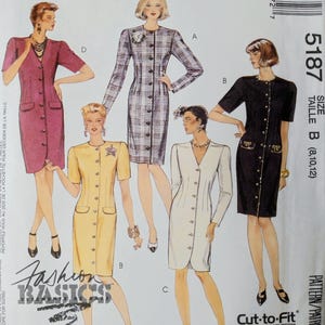 May include: McCall's sewing pattern 5187 for a button-front dress with short or long sleeves. The envelope displays five variations of the dress in magenta, plaid, yellow, white, and black, labeled with letters A, B, C, and D, and includes the text Fashion Basics.
