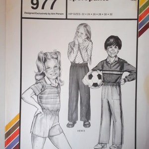 May include: A vintage sewing pattern for children's sport pants. The pattern is for sizes 22 to 32. The pattern is called "Stretch & Sew" and the pattern number is 977. The pattern is designed by Ann Person.
