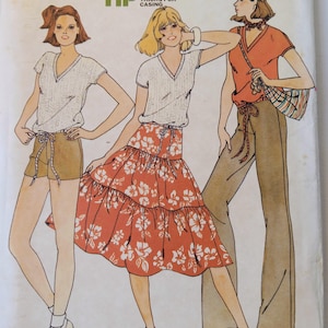 May include: Vintage Butterick sewing pattern 6084, size 9/10. The illustration shows three women wearing tops, shorts, pants, and a tiered skirt. The skirt and top are white with a floral pattern. The pattern includes "Quick Tip" timesaving tricks for casing.