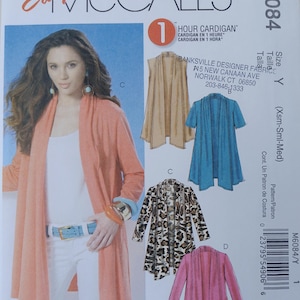 May include: Easy McCall's M6084 sewing pattern for a 1 Hour Cardigan. The envelope features illustrations of four cardigan variations in tan, blue, leopard print, and pink, along with a photo of a person wearing an orange open-front cardigan.