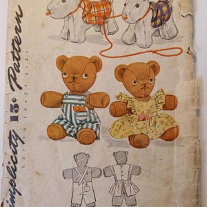 May include: Vintage Simplicity sewing pattern 1149 for making two teddy bears, one wearing overalls and the other a dress. The pattern includes instructions for making two dogs pulling a wagon.