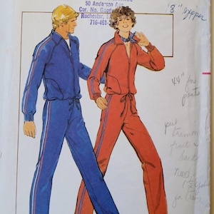 May include: Butterick pattern 5199 for a small size tracksuit. The pattern features illustrations of a blue and a red tracksuit with white and red stripes. The pattern includes the text "FABRICS & FINDINGS" and "SIZED FOR MODERATE STRETCH KNITS ONLY".