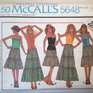 May include: A vintage sewing pattern for a misses' set of tops and skirt. The pattern is McCall's 5648 and is for a size small. The pattern is for tops made from unbonded stretchable knits. The pattern is quick and easy to sew.