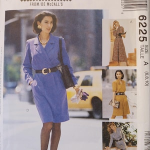 May include: Sew News sewing pattern featuring a woman in a blue dress with a black belt and purse. The pattern includes images of other outfits. Text on the pattern reads "The Fashion Collection From/De McCall's" and "Petite-Able".