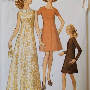 May include: Vintage Simplicity sewing pattern, number 8498, featuring illustrations of three dresses. The dresses are a long, patterned gown, a short-sleeved orange dress, and a long-sleeved brown dress. The pattern includes size 8mp and bust 31 1/2 measurements.