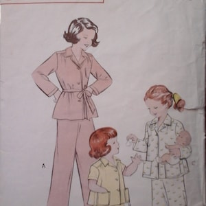 May include: A vintage sewing pattern for pajamas, featuring three figures: a woman and two children. The pattern is for sizes 6 and 24, and costs 35 cents. The pattern is from Butterick, a well-known sewing pattern company.