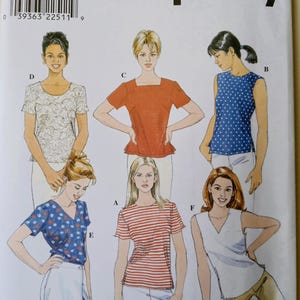 May include: Simplicity sewing pattern 8523 featuring illustrations of various women's tops. The pattern includes designs for tops with different necklines, sleeve lengths, and patterns, including polka dots and stripes. The size range is 8, 10, and 12.