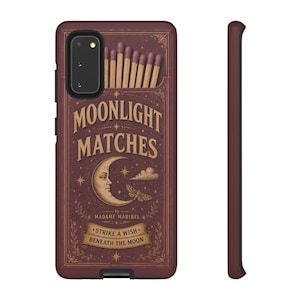 May include: A burgundy phone case featuring a vintage design with the words "MOONLIGHT MATCHES" in gold lettering. The case depicts a crescent moon, stars, and a butterfly. The text "STRIKE A WISH BENEATH THE MOON" is also visible.