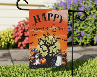 May include: A Halloween garden flag with the words "HAPPY Spooky Season" in black lettering against an orange background. The flag features illustrations of ghosts, pumpkins, bats, a black cat, and a spooky tree.