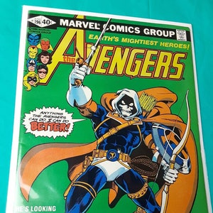 May include: A comic book cover featuring a masked superhero with a bow and arrow. The cover is green and features the text "Earth's Mightiest Heroes!" and "The Avengers". The superhero is wearing a blue and white costume with a skull-like mask. The text "Introducing the Treacherous Taskmaster!" is at the bottom of the cover.