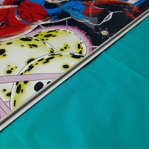 May include: A comic book cover featuring a superhero in a red and blue costume flying through space. The background is a dark blue with stars and planets.