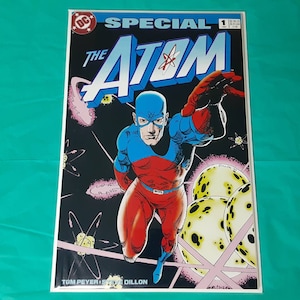 May include: A comic book cover featuring the Atom, a superhero in a red and blue costume, flying through space. The cover is titled "Special The Atom" and is issue number 1. The cover art is by Tom Peyer and Steve Dillon.
