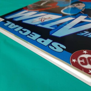 May include: A comic book cover with a blue and white design. The title "The Atom Special" is printed in white letters on a blue background. The DC Comics logo is in the lower right corner.
