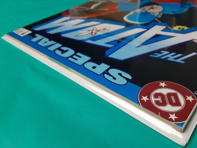 May include: A comic book cover with a blue and white design. The title "The Atom Special" is printed in white letters on a blue background. The DC Comics logo is in the lower right corner.