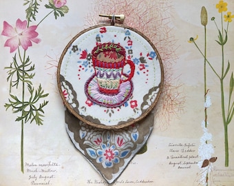 Hand embroidered teacup wall art on antique handkerchief in wooden hoop