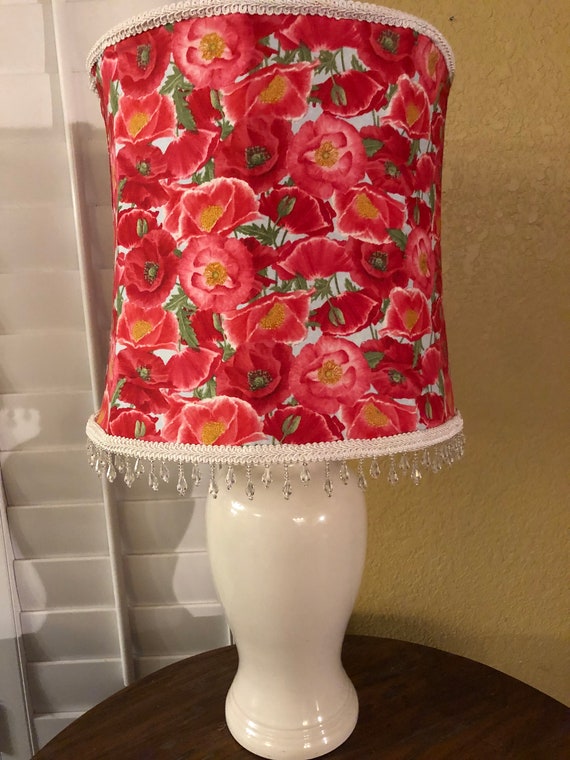 white ceramic lamp with flower on base