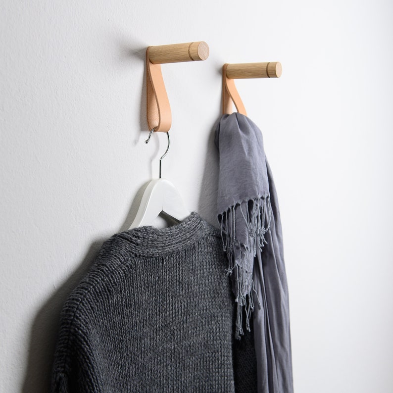 Minimalistic wooden wall hooks made of high-quality oak. You can install these Scandinavian inspired hooks in the entryway or around the house as a: coat hook, wall holder for plants, towel holder, or for other applications.