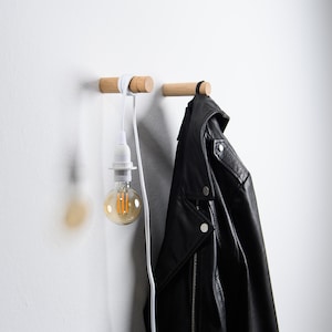Minimalistic wooden wall hooks made of high-quality oak. You can install these Scandinavian inspired hooks in the entryway or around the house as a: coat hook, wall holder for plants, towel holder, or for other applications.
