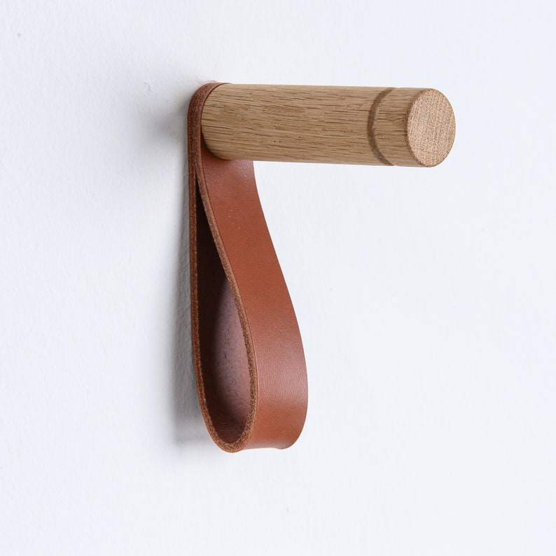 Minimalistic wooden wall hooks made of high-quality oak. You can install these Scandinavian inspired hooks in the entryway or around the house as a: coat hook, wall holder for plants, towel holder, or for other applications.