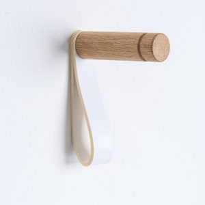 Minimalistic wooden wall hooks made of high-quality oak. You can install these Scandinavian inspired hooks in the entryway or around the house as a: coat hook, wall holder for plants, towel holder, or for other applications.