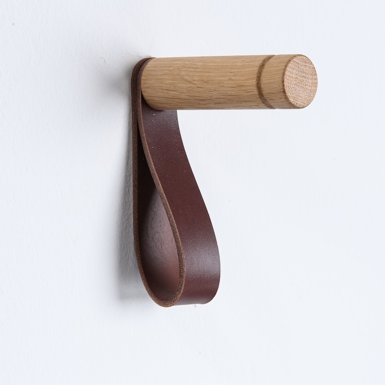 Minimalistic wooden wall hooks made of high-quality oak. You can install these Scandinavian inspired hooks in the entryway or around the house as a: coat hook, wall holder for plants, towel holder, or for other applications.