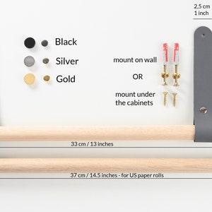 May include: A wooden towel bar with leather straps in gray. The bar is 13 inches long and can be mounted on a wall or under cabinets. It comes with screws and anchors for installation. The bar is available in black, silver, or gold finishes.