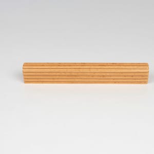 Side view of beech wood cabinet handle showing thickness and texture ribbed design and smooth finish