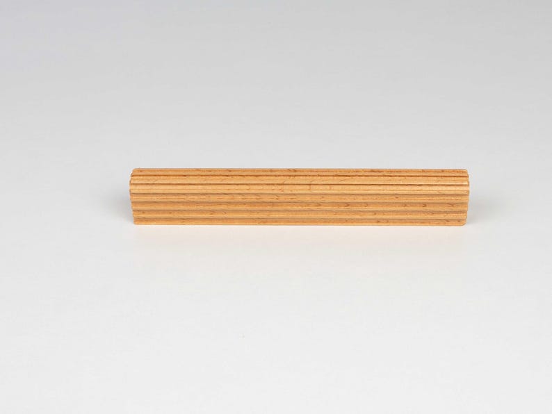 Side view of beech wood cabinet handle showing thickness and texture ribbed design and smooth finish