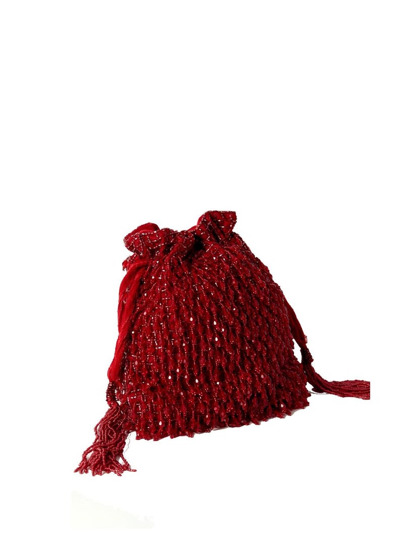 May include: A red beaded drawstring bag with a tassel. The bag is made of small, round beads that are sewn together to create a textured surface.