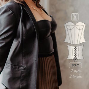 May include: A black leather jacket with a brown pleated skirt. A white corset pattern with a lace-up back is shown on the right side of the image. The text "80 C, 2 styles, 2 lengths" is below the pattern.