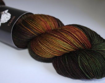 May include: A skein of yarn with a blend of colors including brown, green, and orange. The yarn is wound into a ball shape, with a label that reads "Yarns". The yarn appears soft and suitable for knitting or crochet projects.