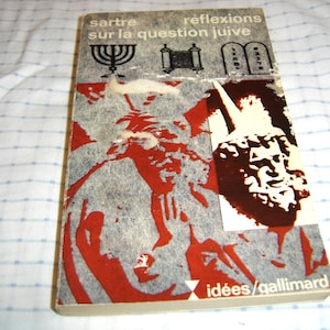May include: A vintage book titled "sartre réflexions sur la question juive" with a gray and red cover. The cover features illustrations of a menorah, Torah scroll, and tablets. The book is from the "idées/gallimard" series.