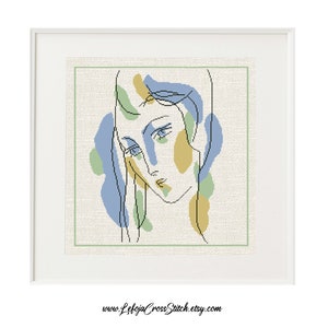 Puede incluir: Un patrón de punto de cruz de la cara de una mujer con formas abstractas en azul, verde y amarillo.