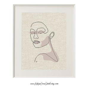 Può includere: Un disegno a linea di un viso con uno sfondo rosa. Il disegno è in stile minimalista ed è perfetto per una casa moderna.
