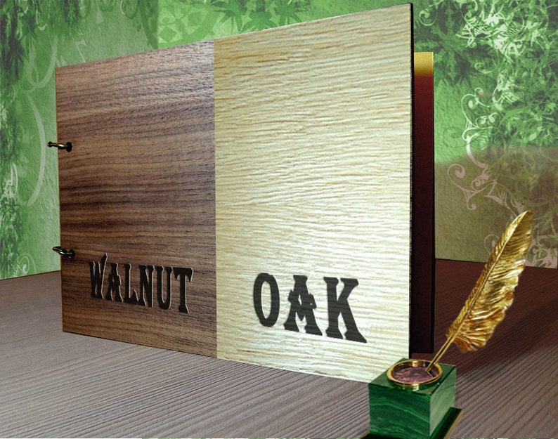 May include: A wooden photo album with a walnut and oak cover. The album is closed and has two metal hinges. The words "WALNUT" and "OAK" are printed on the cover.