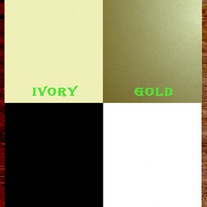 May include: A color chart with four squares showing the colors ivory, gold, black, and white.